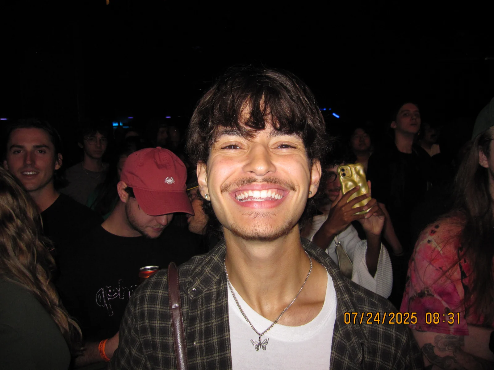 Thomas smiling brightly during an evening out