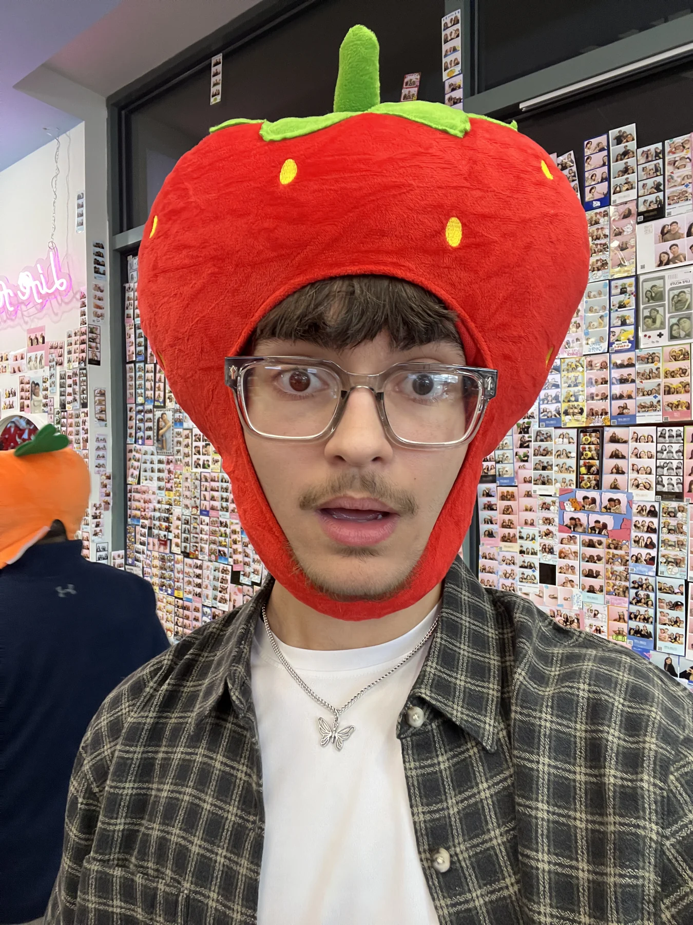 Thomas wearing glasses and a playful strawberry hat